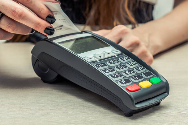Credit or debit card password payment. Customer hand is entering personal identification number in shop or supermarket. Payment terminal keypad, pin.  Buy and sell products and service. Close-up, selective focus. - Foto, afbeelding
