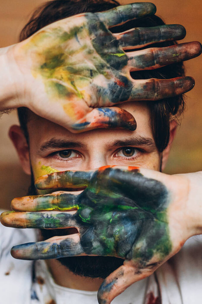 Portrait of an artist with paints on his face and clothes - Fotoğraf, Görsel