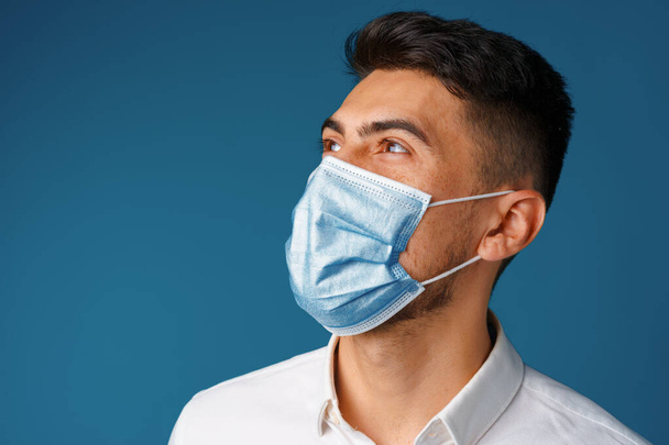 Handsome mixed-race man wearing medical face mask - 写真・画像