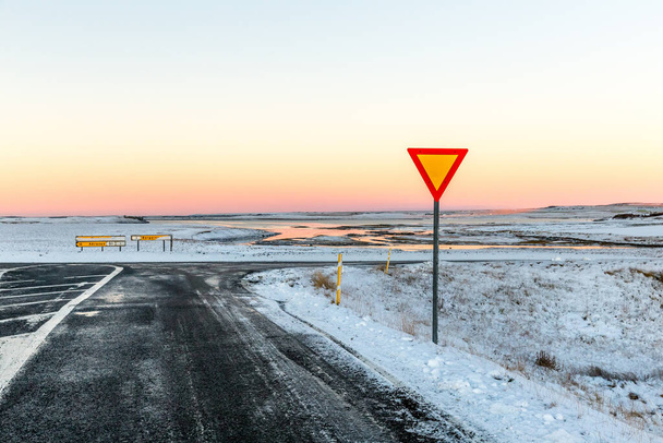 A highway intersection with yield sign in Iceland - 写真・画像