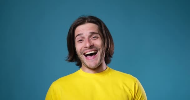 Iloinen mies nauraa sinisellä taustalla - Materiaali, video