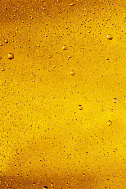 Close up view of cold drops on the glass of beer - Fotó, kép