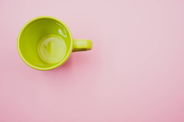 A light green mug on a light pink background - Foto, immagini