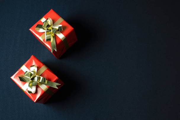 A top view of red Christmas gift boxes isolated on a dark background - Fotoğraf, Görsel
