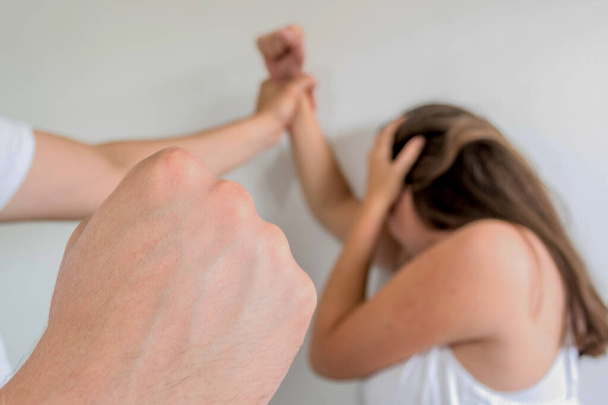 A male hitting on a female, the concept of domestic violence against women - Fotoğraf, Görsel