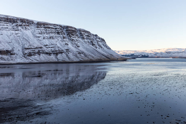 Formacja skalna odbita na jeziorze we Fjord, Islandia - Zdjęcie, obraz