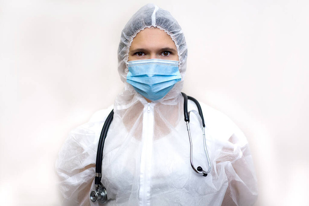 Female doctor in PPE suit uniform and Santa Claus hat.Concept of Covid-19 quarantine. - Photo, image