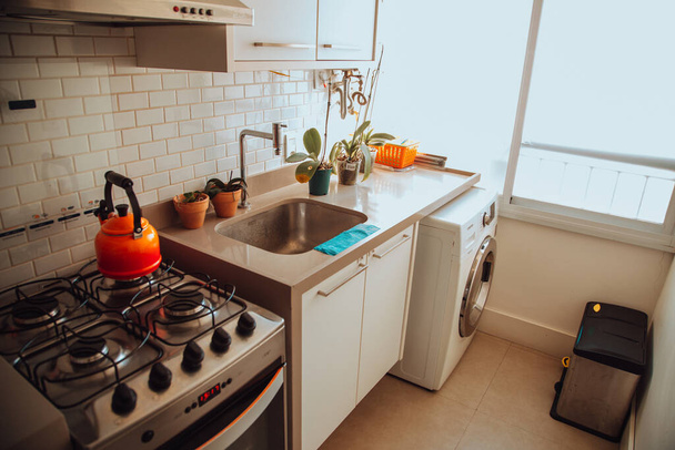 A cozy residential kitchen with windows - Фото, зображення
