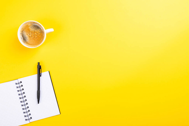 The flat lay of the office working tools on the yellow surface - space for text - Фото, изображение