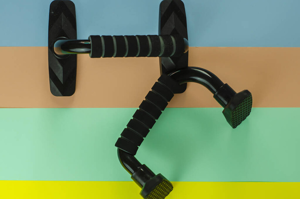 A closeup shot of push-up racks on a fitness matte - Φωτογραφία, εικόνα