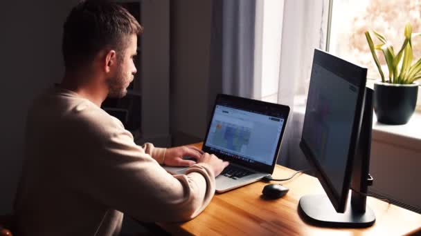 İşadamı odaklı girişimci dizüstü bilgisayarla araştırma yapıyor. Bilgisayarı kullanan genç profesyonel bir erkek ofis masasında oturuyor. Modern teknoloji not defteri üzerinde çalışan meşgul bir işçi.. - Video, Çekim