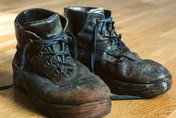 Old worn work boots with lacing. Leather shoes that require repair or replacement. Closeup - Photo, Image