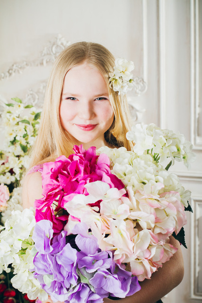 Portrait of attractive girl with a bouquet of flowers - Фото, изображение