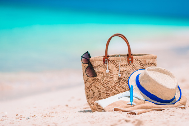 Beach accessories - straw bag, hat and unglasses on the beach - Photo, Image