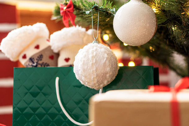Xmas, winter, new year, Celebration, family, gift concept - Holiday atmosphere at home. Bright presents boxes under Christmas tree decorated with balls on background red fireplace with burning fire - Foto, afbeelding