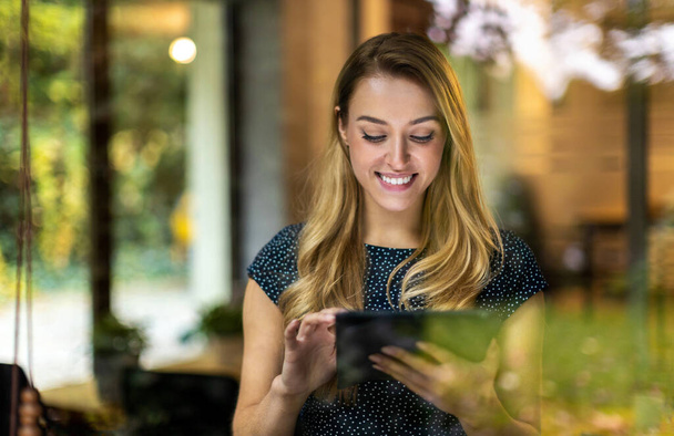 Young businesswoman using digital tablet in her office - Foto, Bild