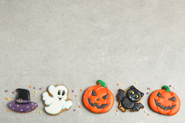 Tasty Halloween cookies on light grey table, flat lay. Space for text - Photo, Image