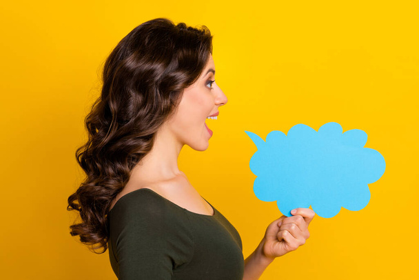 Close-up profile side view portrait of her she nice attractive lovely cheerful wavy-haired girl saying info copy space cloud isolated on bright vivid shine vibrant yellow color background - Φωτογραφία, εικόνα