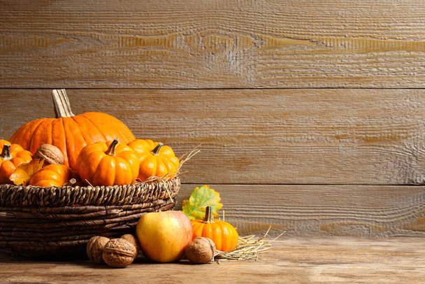Composition with ripe pumpkins on wooden table, space for text. Happy Thanksgiving day - Фото, зображення