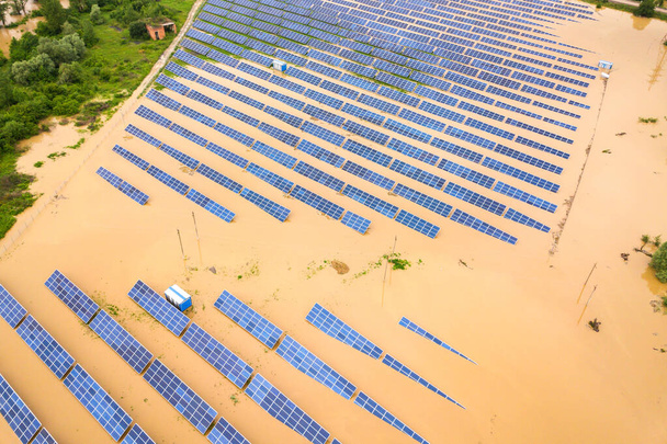 Aerial view of flooded solar power station with dirty river water in rain season. - Photo, Image