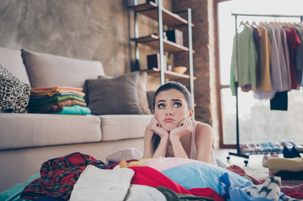 Photo of pretty stressed crying lady stay home quarantine lying many clothes heap stack floor wardrobe stuff pick select date look outfit nothing to wear concept living room indoors - Foto, Bild