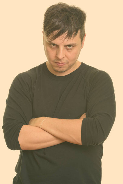 Studio shot of man wearing long sleeved shirt isolated against white background - Fotografie, Obrázek
