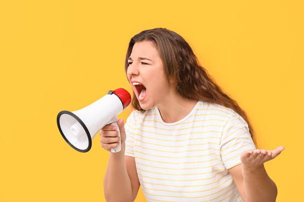 Protesting woman with megaphone on color background - Foto, Imagen