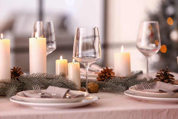 Beautiful table setting with Christmas decorations in living room - Фото, зображення