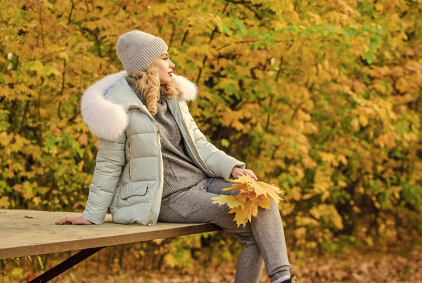 Clothes for rest. Girl relaxing in nature wearing knitwear suit and jacket. Model knitwear clothes leaves background. Feel practicality and comfort. Woman enjoy autumn season in park. Warm knitwear - Photo, image