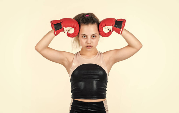 show her biceps. teen girl boxer. sportswear and equipment shop. healthy lifestyle. energetic kid power. child workout isolated on white. small girl training in boxing gloves. sport and fitness - Foto, Imagem