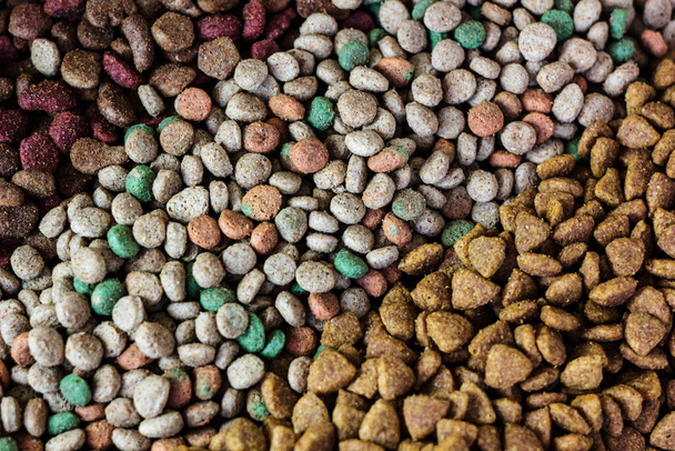 Dry pet food background - three kinds. Meat. - Фото, изображение