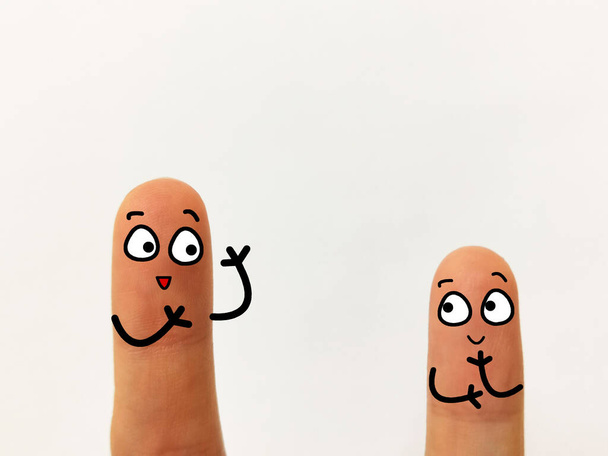 Two fingers are decorated as two person. They are discussing about some social issues. - Photo, Image