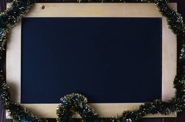 Blackboard with place for your text, surrounded by christmas garland - Fotoğraf, Görsel