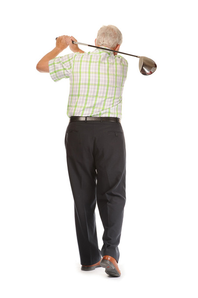 Happy casual mature golfer swinging a club - Фото, зображення