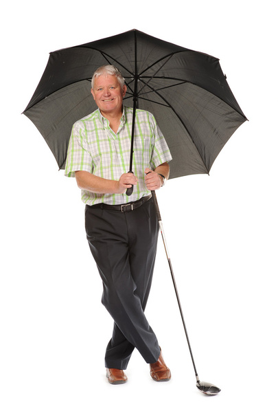 Happy casual mature golfer with umbrella - Fotó, kép