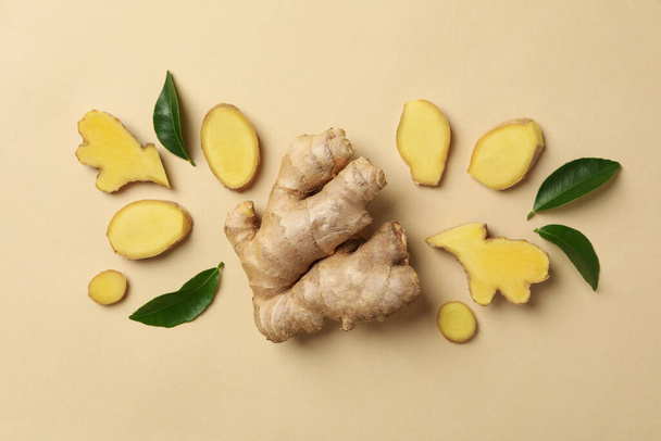 Fresh ginger and leaves on beige background - Photo, image