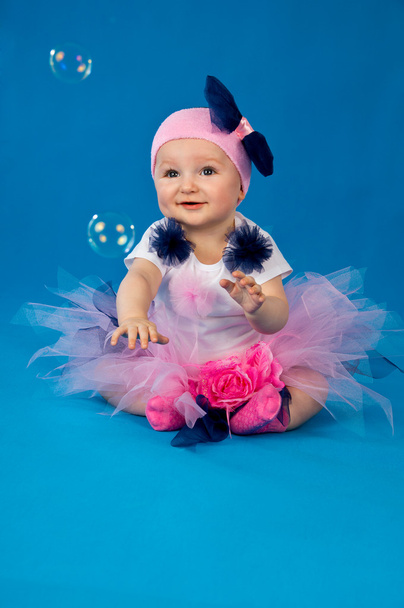 Baby and soap bubbles on a blue background - Photo, Image