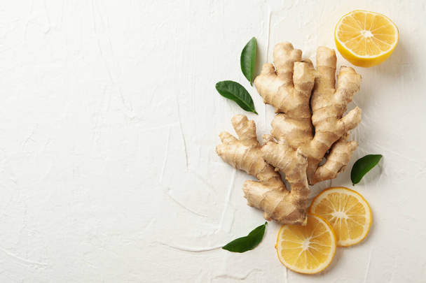 Fresh raw ginger and lemon on white background - Foto, imagen