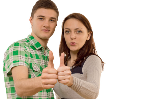 Motivated young couple giving a thumbs up - 写真・画像