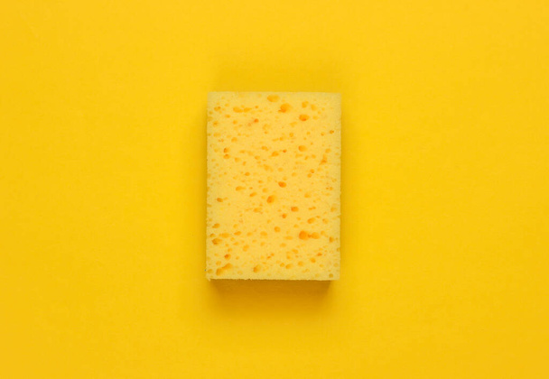 Ready for cleaning! Sponge on a yellow background. Minimalism. Top view - Photo, Image