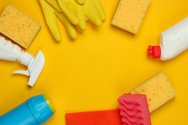 Set of products for cleaning the house on a yellow background. Top view. Copy space - Zdjęcie, obraz