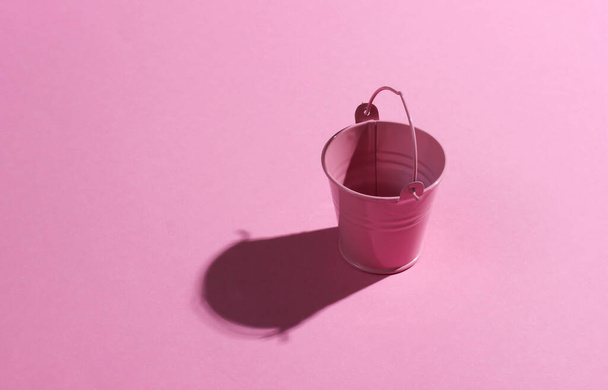 Empty mini pink bucket on pink background. Studio shot with shadow - Fotó, kép
