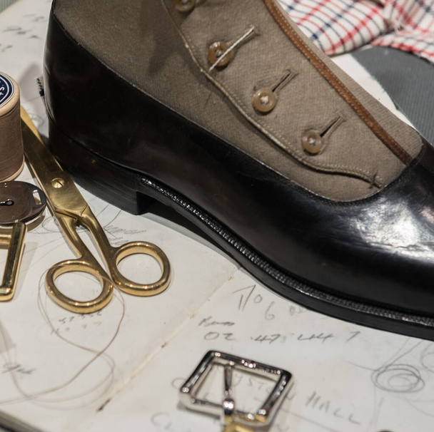 Cobblers' Table With Gold Buckles, Various Accessories,  Leather Shoes and Sketch Drawings - Photo, Image