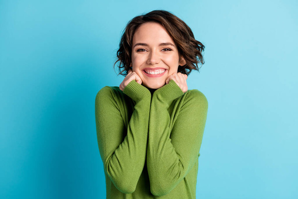 Portrait of sweet girl touch hands chin toothy smile appreciate cozy weekend wear style stylish trendy sweater isolated over blue color background - Fotó, kép