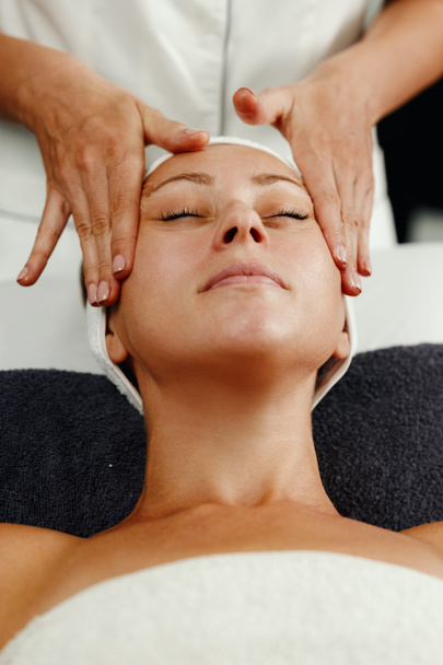 Shot of a beautiful mature woman enjoying face massage at the beauty salon. - Foto, Imagem