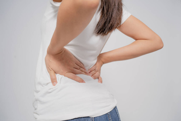 Asian woman has back pain with isolated background. - Foto, Bild