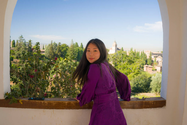 lifestyle portrait of young beautiful and happy Asian Japanese tourist woman having Summer holidays in Europe enjoying cheerful visiting beautiful Alhambra of Granada in Spain - Photo, Image