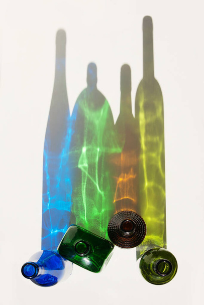 Coloured shadows of empty glass bottles. - Fotó, kép