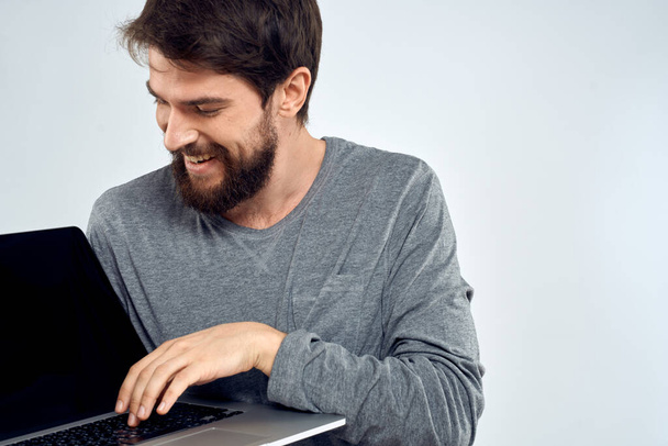A man in a gray sweater with a laptop hands lifestyle technology communication internet work - Fotografie, Obrázek