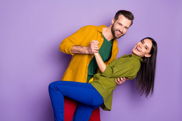 Profile photo pretty lady handsome guy couple hugging holding hands have fun slow dancing good mood quarantine time wear casual shirts trousers isolated purple color background - Foto, immagini
